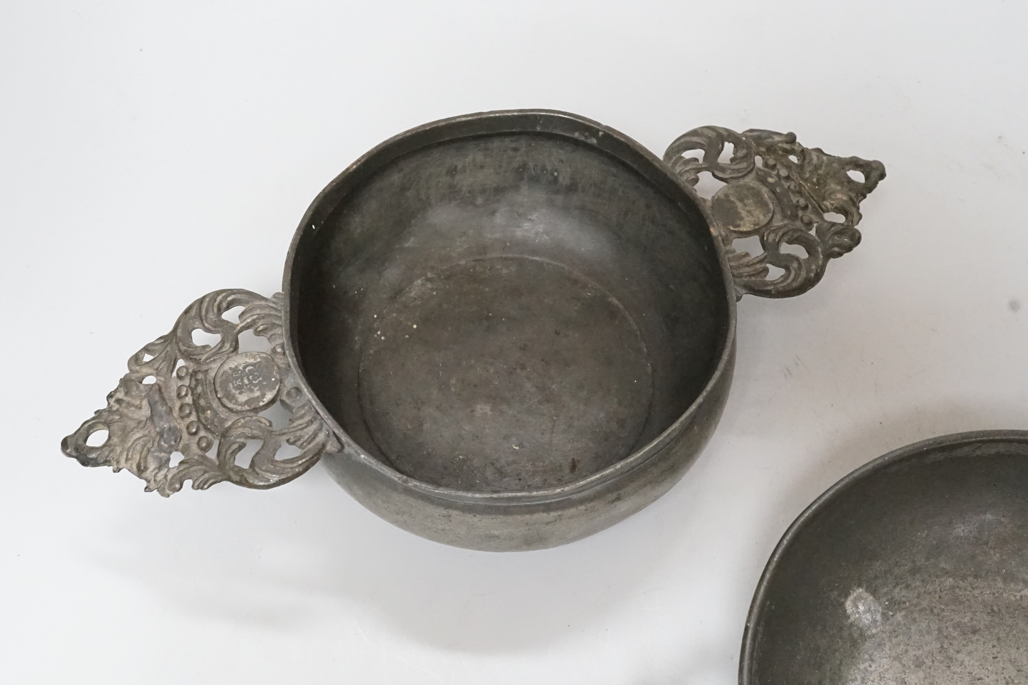 An 18th century French pewter two handled ecuelle, lacking cover, and one other, largest 27cm wide, (2)